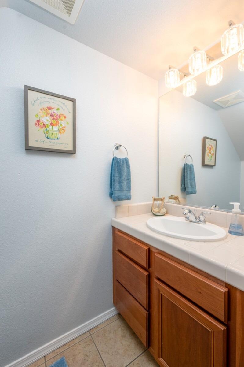 1968 North Tuscany Lane Clovis, CA 93619 - Photo 11 of 40 a bathroom with a sink and a mirror