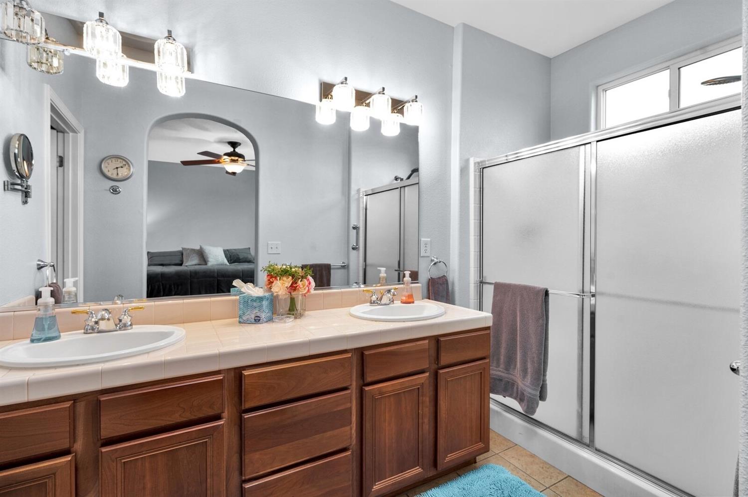 1968 North Tuscany Lane Clovis, CA 93619 - Photo 16 of 40 a bathroom with a double vanity sink and a mirror
