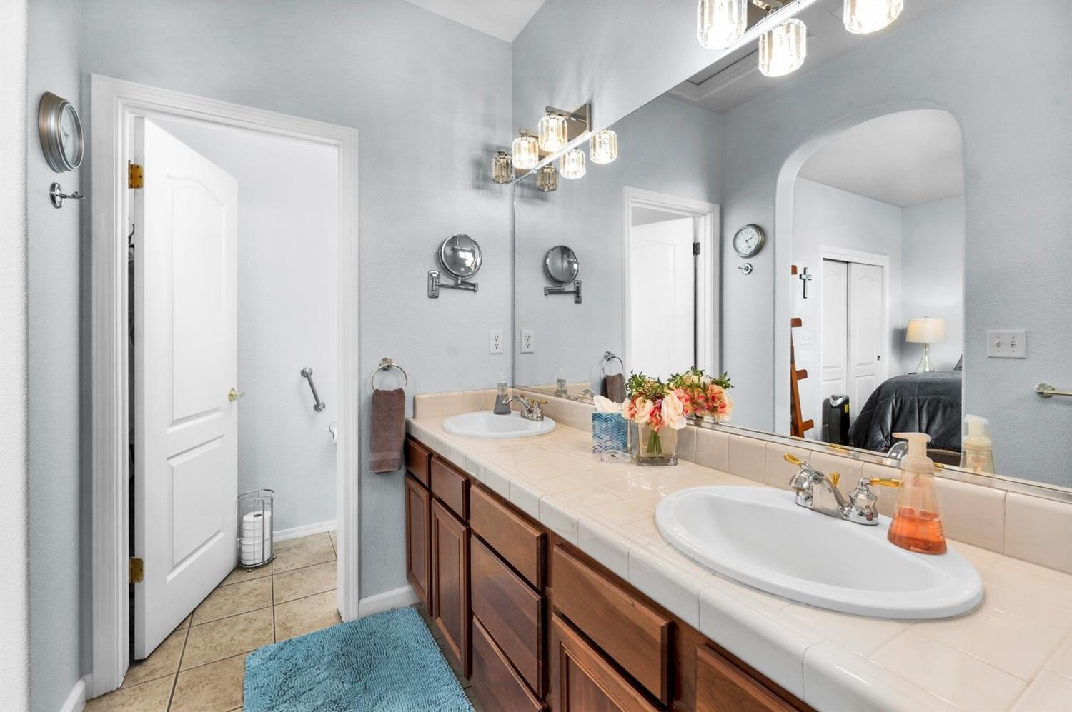 1968 North Tuscany Lane Clovis, CA 93619 - Photo 17 of 40 a bathroom with a double vanity sink and a mirror