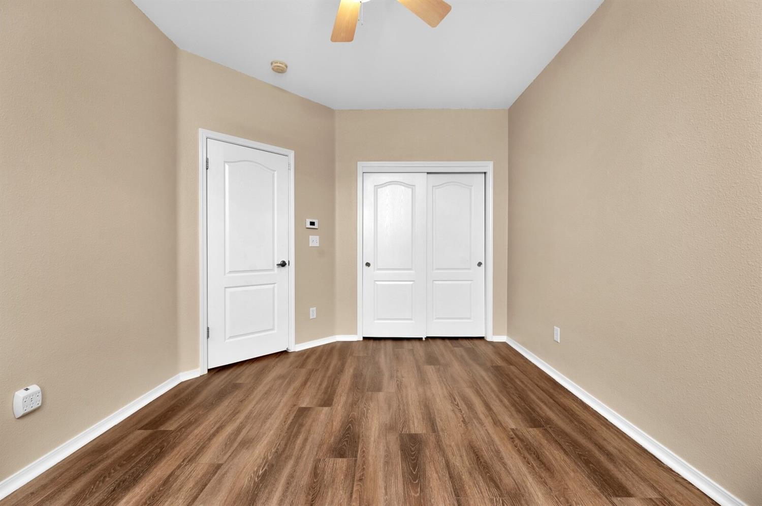 1968 North Tuscany Lane Clovis, CA 93619 - Photo 21 of 40 an empty room with wooden floor and windows