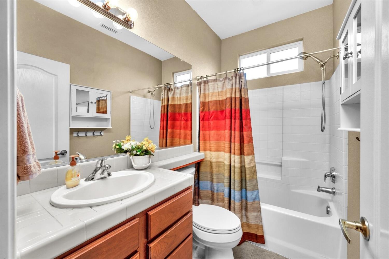 1968 North Tuscany Lane Clovis, CA 93619 - Photo 22 of 40 a bathroom with a sink toilet and shower