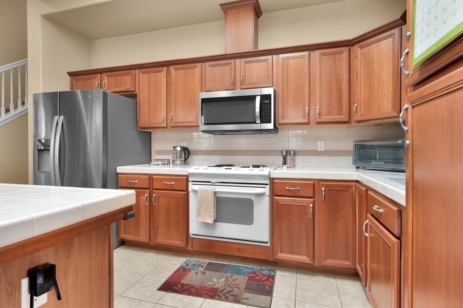 1968 North Tuscany Lane Clovis, CA 93619 - Photo 6 of 40 a kitchen with stainless steel appliances granite countertop a refrigerator stove top oven a sink and dishwasher
