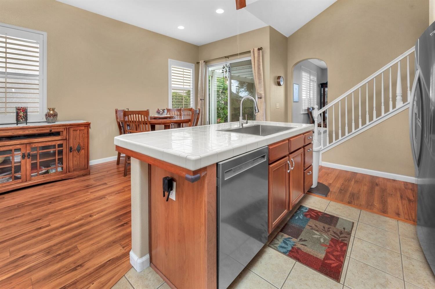 1968 North Tuscany Lane Clovis, CA 93619 - Photo 8 of 40 a kitchen with stainless steel appliances granite countertop a sink stove and wooden floor