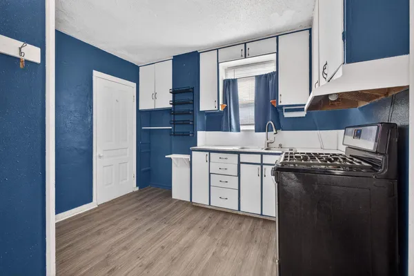a kitchen with stainless steel appliances granite countertop a stove a refrigerator and a sink