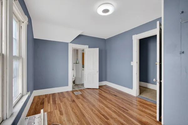 a view of a room with wooden floor and bathroom