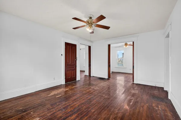 a view of an empty room with wooden floor