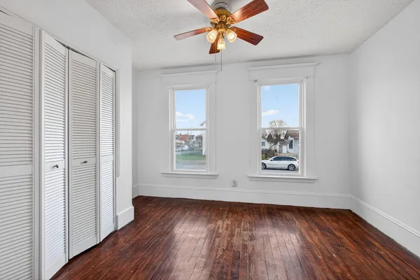 wooden floor in an empty room with a window