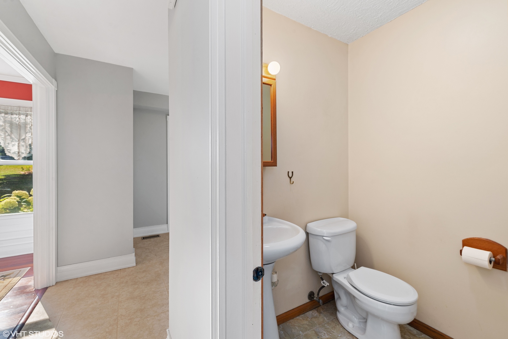 40W574 Bowes Road Elgin, IL 60124 - Photo 14 of 25 a white toilet sitting next to a bathroom sink and vanity