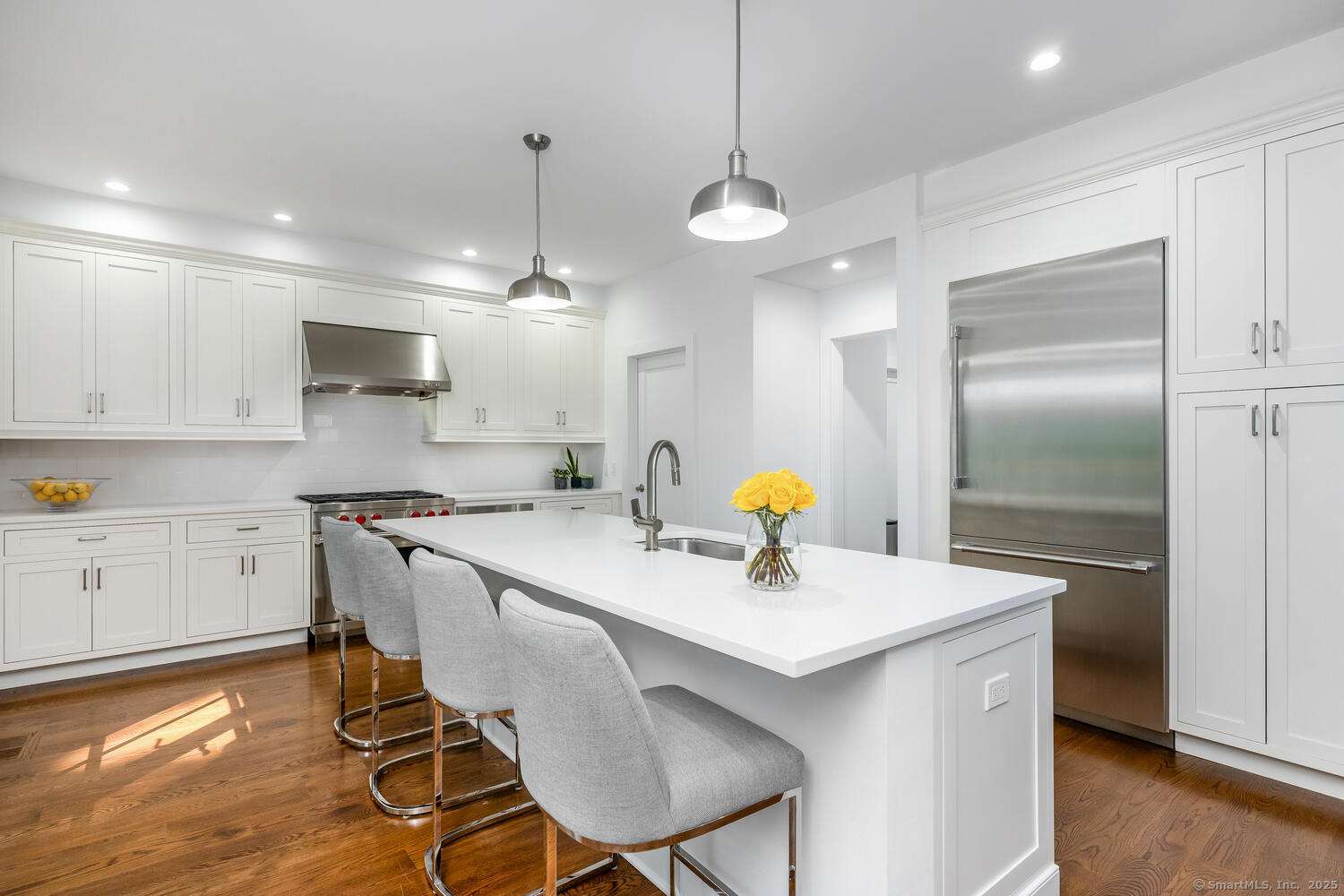 72 Kensett Lane Darien, CT 06820 - Photo 15 of 39 a kitchen with a dining table chairs sink and cabinets