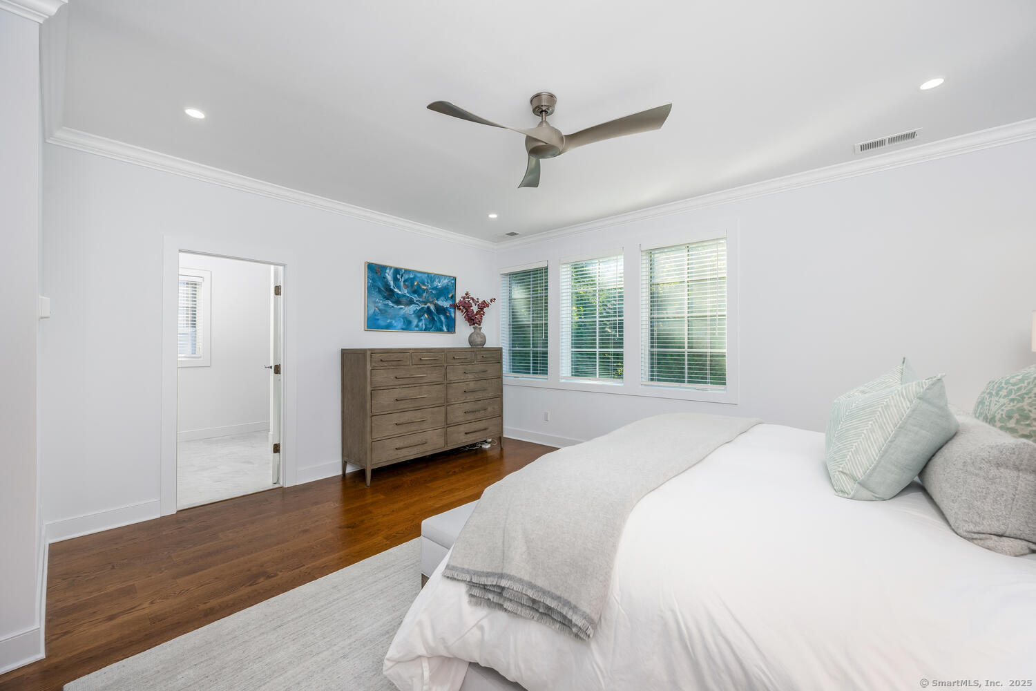 72 Kensett Lane Darien, CT 06820 - Photo 18 of 39 a spacious bedroom with a bed and a large window