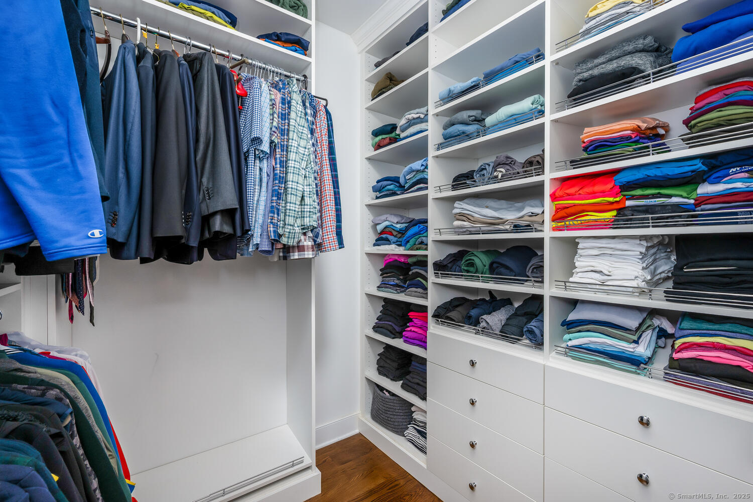72 Kensett Lane Darien, CT 06820 - Photo 20 of 39 a view of walk in closet with clothes and shoes