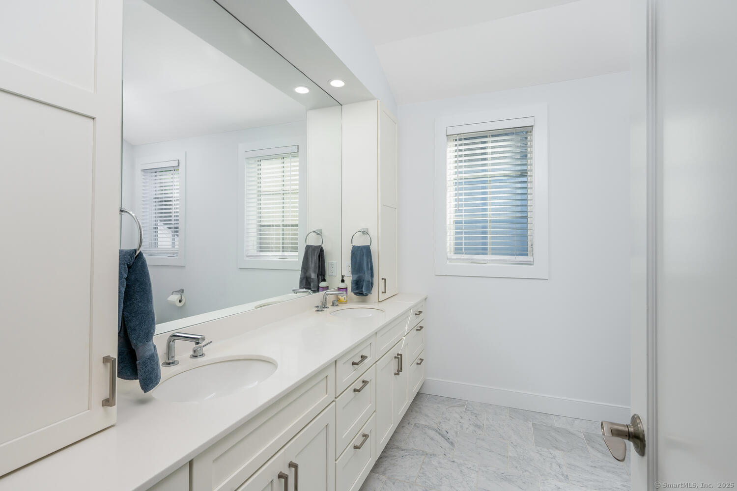 72 Kensett Lane Darien, CT 06820 - Photo 21 of 39 a bathroom with a sink a vanity and a mirror
