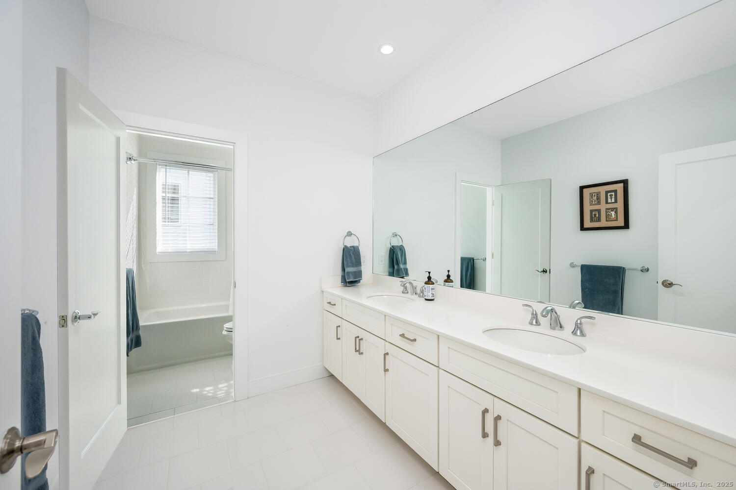 72 Kensett Lane Darien, CT 06820 - Photo 26 of 39 a bathroom with a double vanity sink and mirror