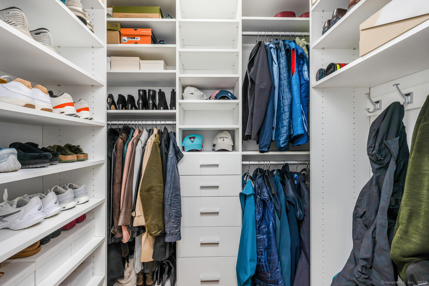 72 Kensett Lane Darien, CT 06820 - Photo 27 of 39 a view of walk in closet with clothes and shoes