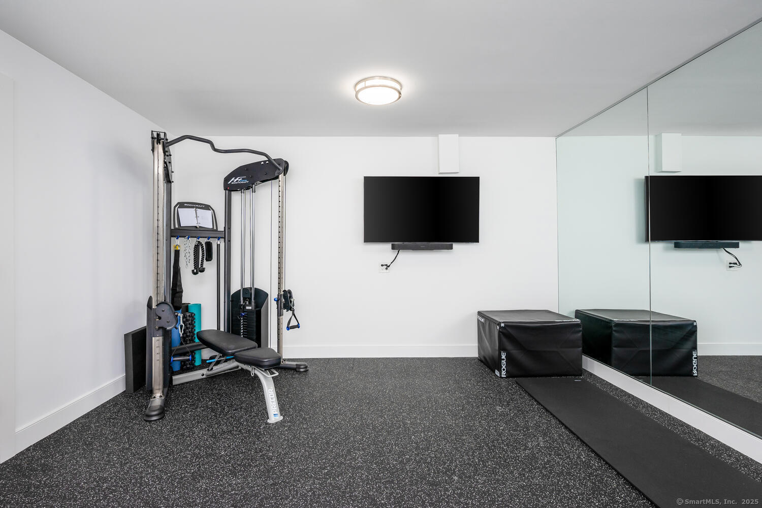 72 Kensett Lane Darien, CT 06820 - Photo 33 of 39 a view of a livingroom with furniture and a flat screen tv