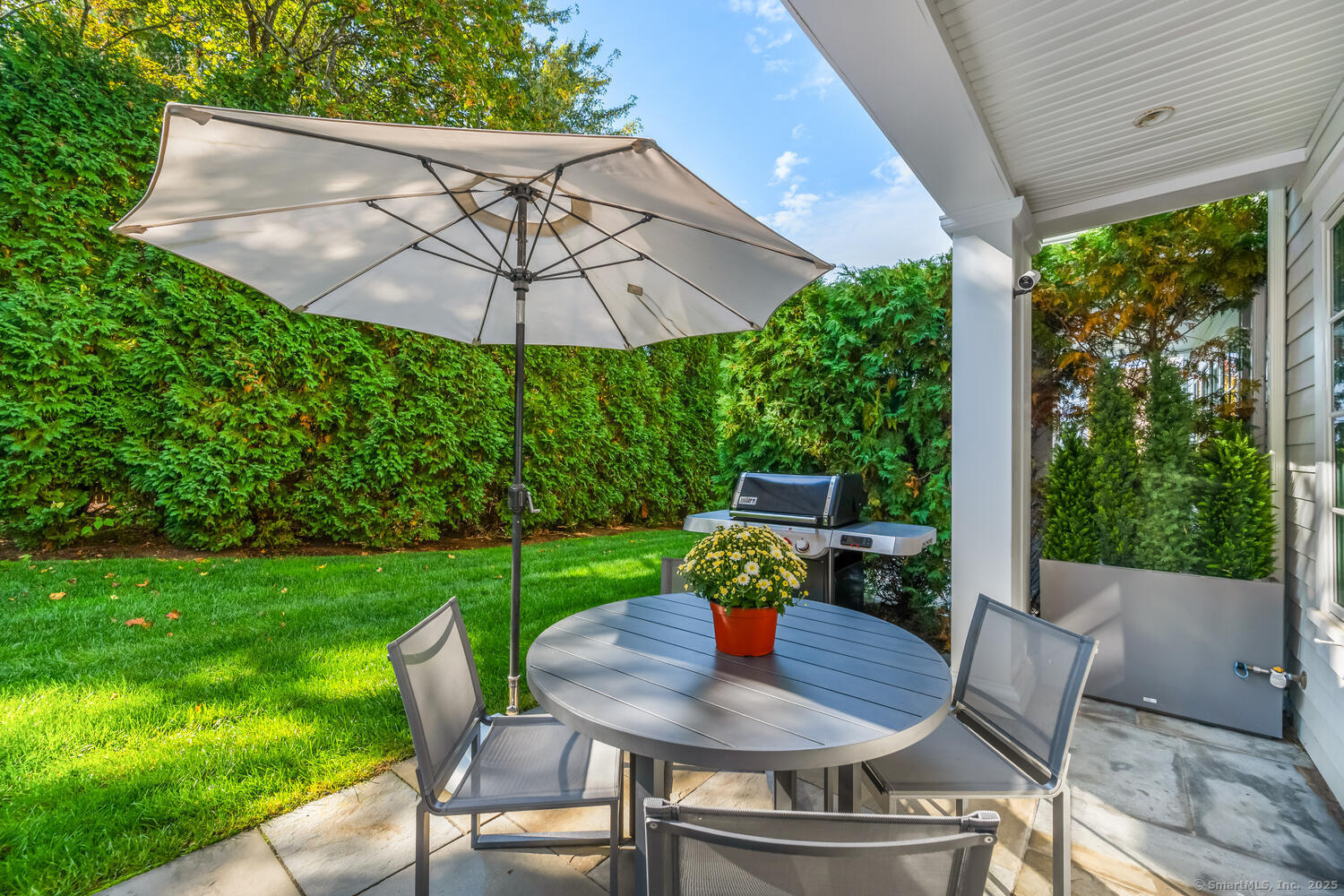 72 Kensett Lane Darien, CT 06820 - Photo 34 of 39 a view of a patio with a table chairs and a backyard