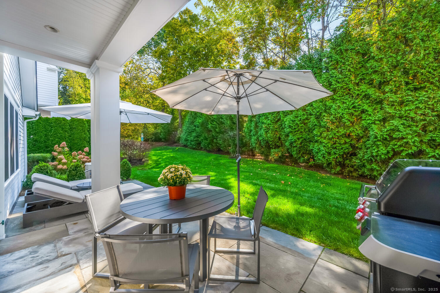 72 Kensett Lane Darien, CT 06820 - Photo 35 of 39 a view of a patio with a table chairs and a table