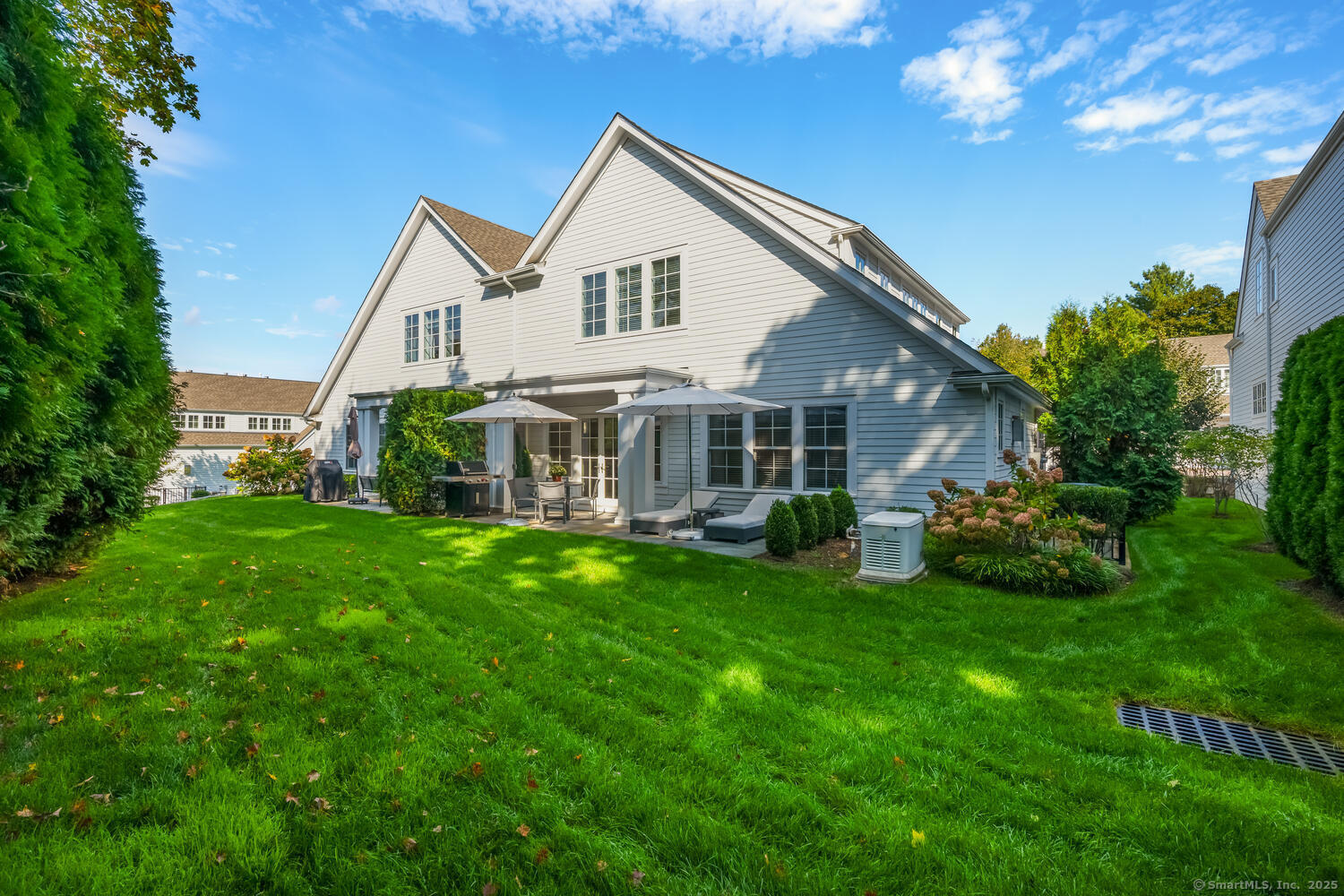 72 Kensett Lane Darien, CT 06820 - Photo 36 of 39 a front view of a house with a garden and porch