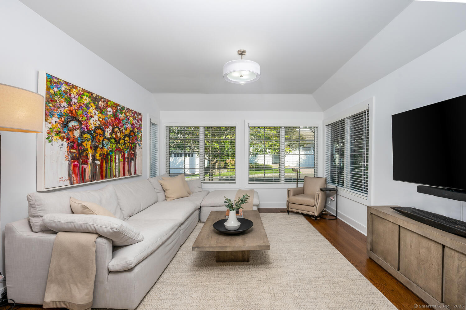 72 Kensett Lane Darien, CT 06820 - Photo 10 of 39 a living room with furniture a flat screen tv and a large window