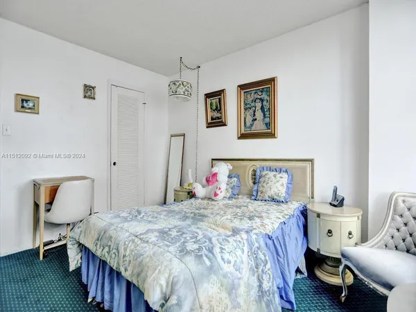 a bedroom with a bed and chair