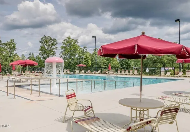 a view of a patio with a table and chairs under an umbrella