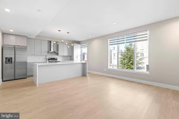 a kitchen with stainless steel appliances a refrigerator sink and cabinets