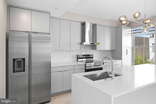 a kitchen with a refrigerator a sink and cabinets