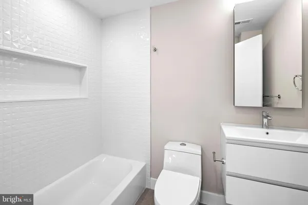 a bathroom with a toilet a sink and bathtub