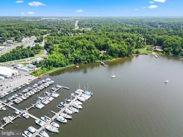 an aerial view of a houses with a yard and lake view
