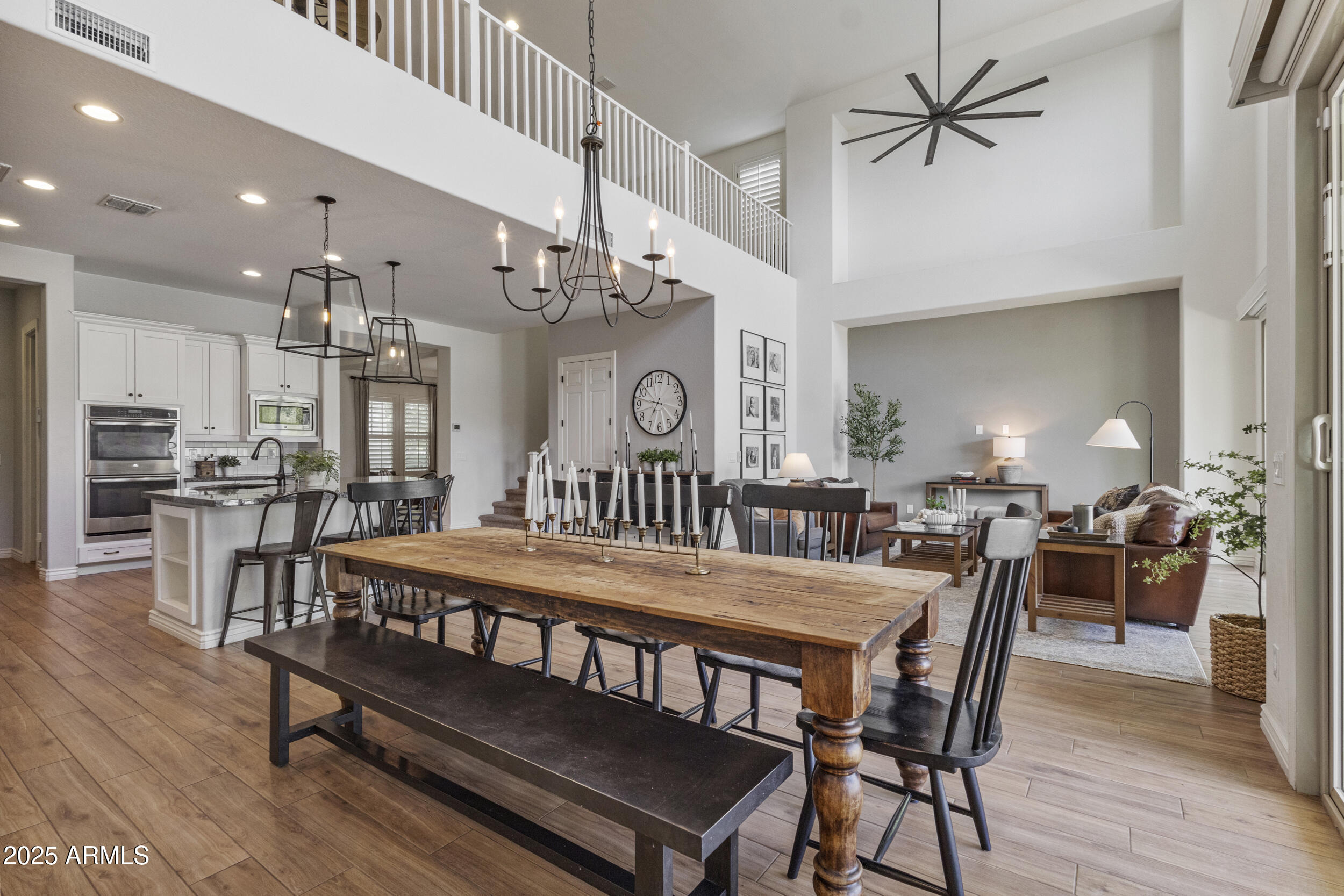 4292 East Morrison Ranch Parkway Gilbert, AZ 85296 - Photo 5 of 55 a view of a dining room with furniture and wooden floor