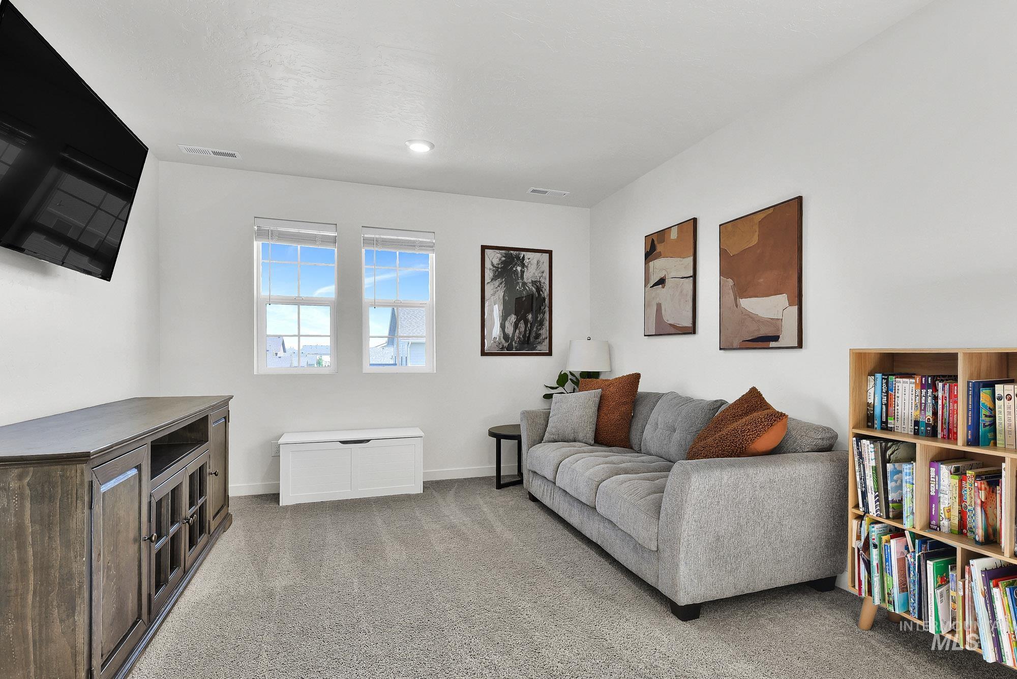 717 West Lyra Street Meridian, ID 83642 - Photo 23 of 50 Carpeted room featuring dual windows with blinds, a wall-mounted television, and recessed lighting