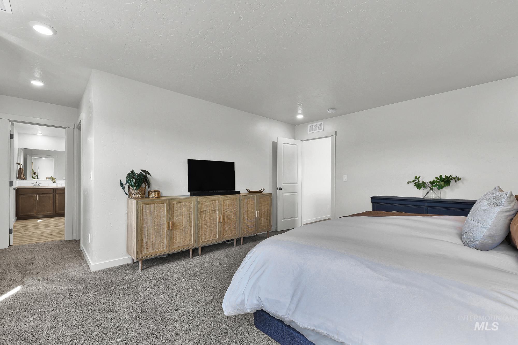 717 West Lyra Street Meridian, ID 83642 - Photo 26 of 50 Spacious carpeted room featuring recessed lighting and a white paneled door