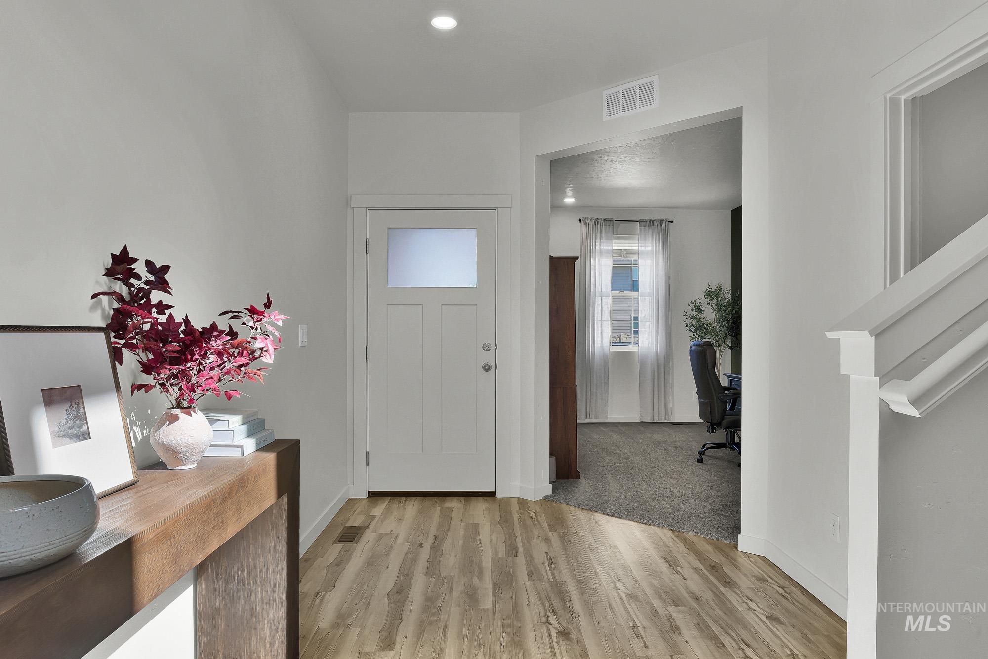 717 West Lyra Street Meridian, ID 83642 - Photo 3 of 50 Entryway featuring wood-finish flooring, a white paneled door with frosted glass, and recessed lighting