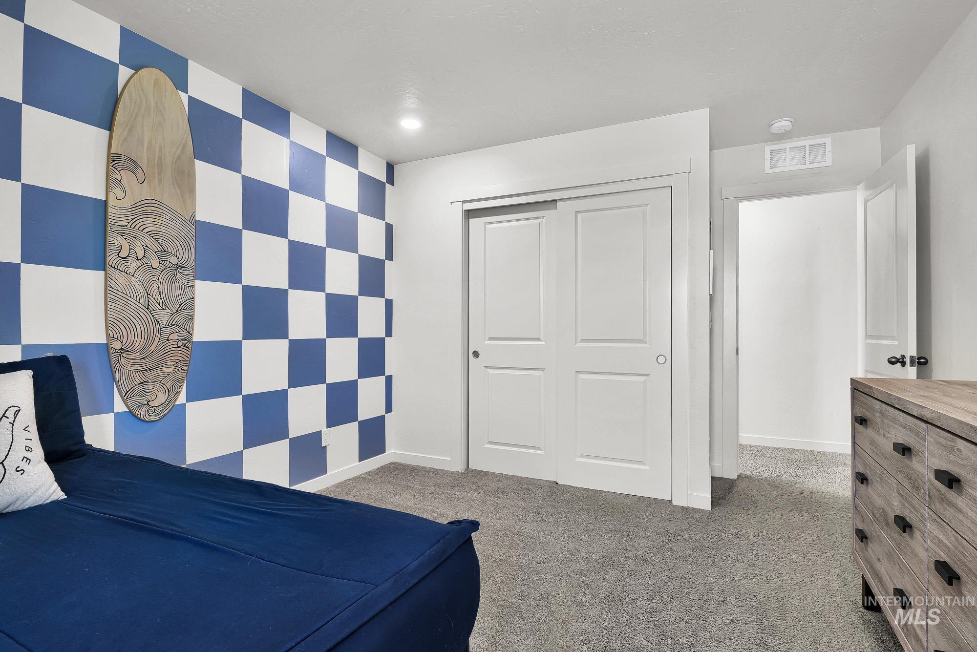 717 West Lyra Street Meridian, ID 83642 - Photo 36 of 50 Carpeted room featuring a distinctive checkered accent wall
