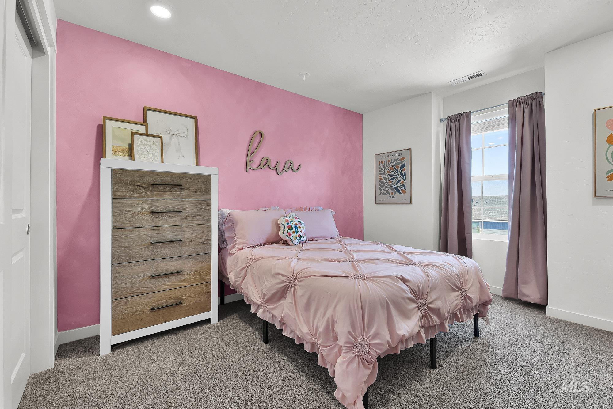 717 West Lyra Street Meridian, ID 83642 - Photo 37 of 50 Bedroom featuring a textured accent wall, recessed lighting, and a window with curtains