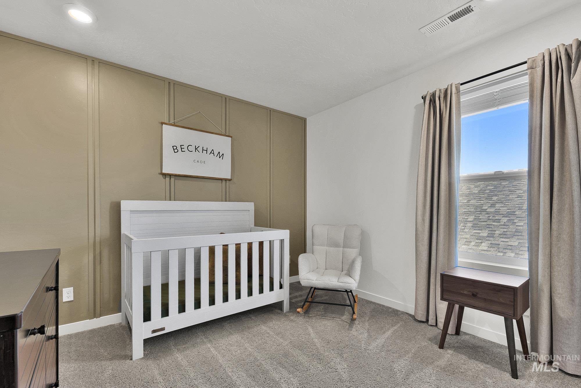 717 West Lyra Street Meridian, ID 83642 - Photo 39 of 50 Accent wall with vertical paneling, recessed lighting, carpet flooring, window with drapes, and white baseboards