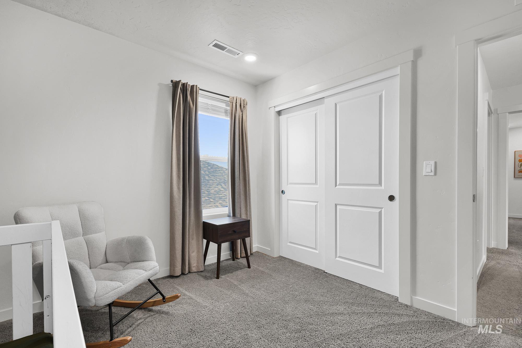717 West Lyra Street Meridian, ID 83642 - Photo 40 of 50 Light-colored carpeting, white walls, and a window with mountain scenery