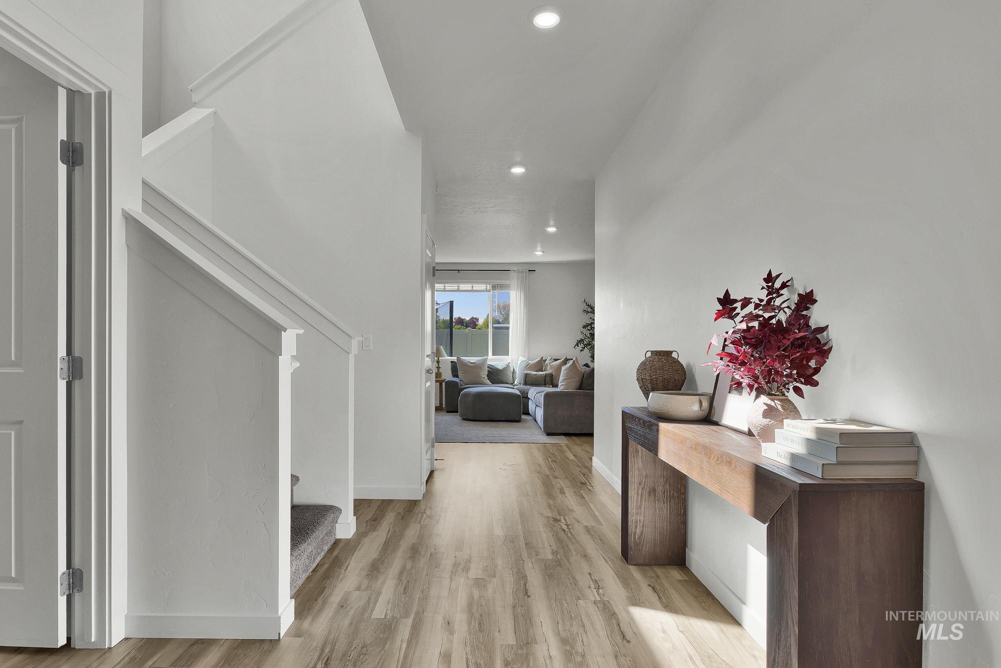 717 West Lyra Street Meridian, ID 83642 - Photo 4 of 50 Spacious hallway featuring wood-finish flooring, recessed lighting, and a neutral color palette