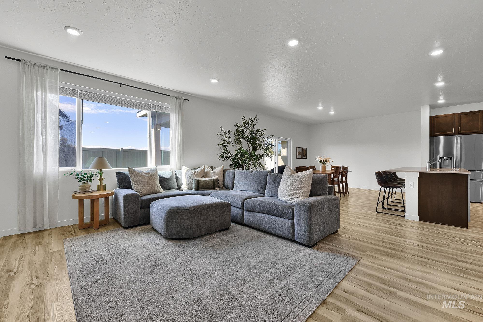 717 West Lyra Street Meridian, ID 83642 - Photo 8 of 50 Open-concept living area featuring light wood-finish flooring and recessed lighting