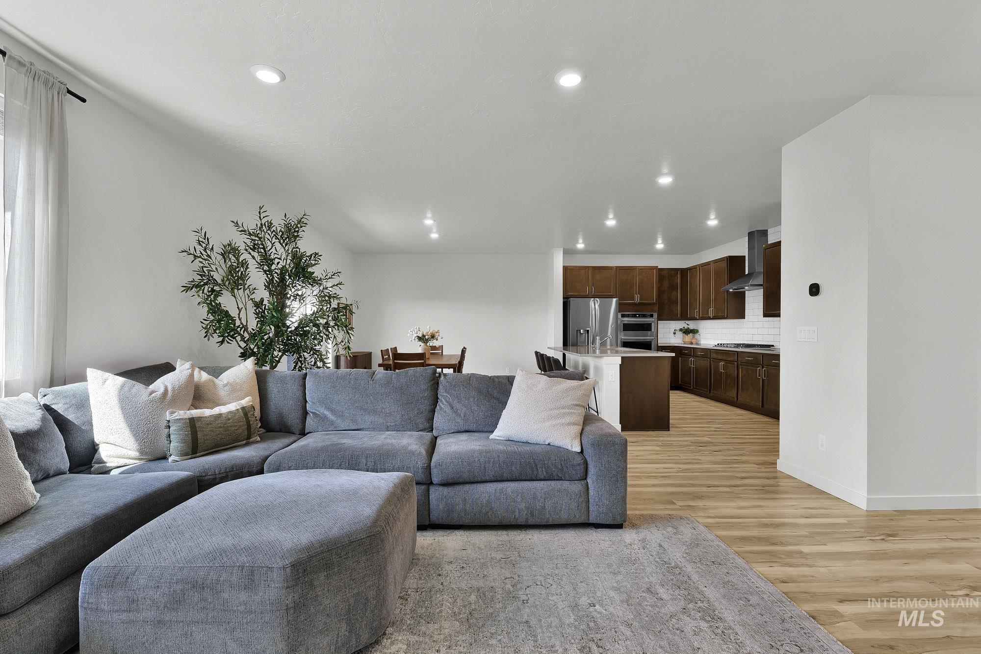 717 West Lyra Street Meridian, ID 83642 - Photo 10 of 50 Open concept living area featuring wood-finish flooring