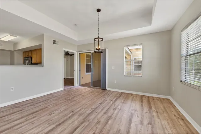 a view of empty room with wooden floor and window