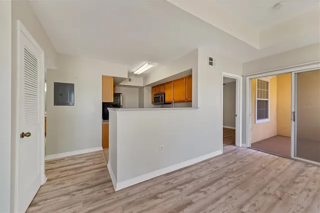 a view of a livingroom with wooden floor and a flat screen tv