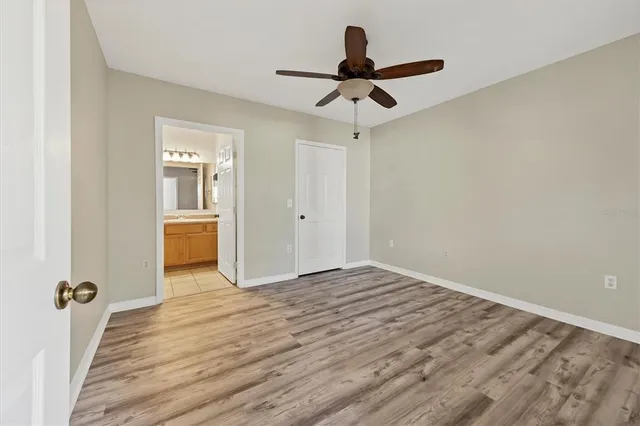 a view of a livingroom with a ceiling fan and wooden floor