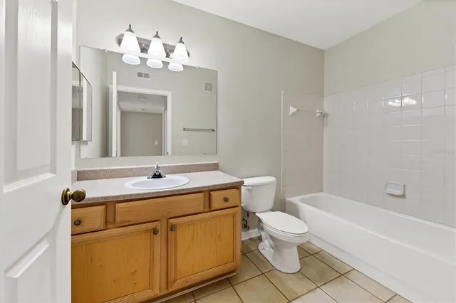 a bathroom with a toilet a sink and bathtub