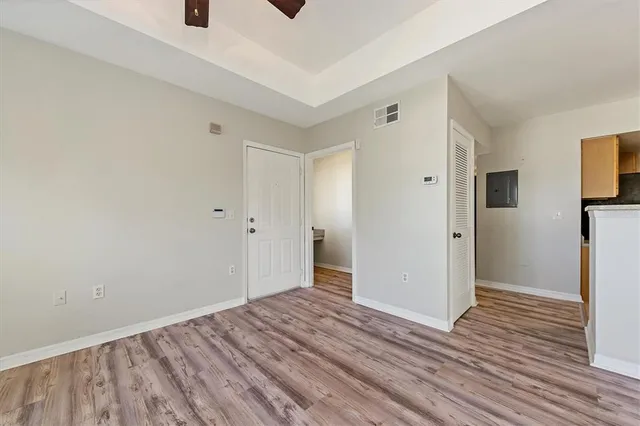a view of a room with wooden floor