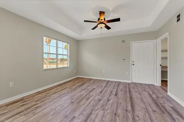 wooden floor in an empty room with a window