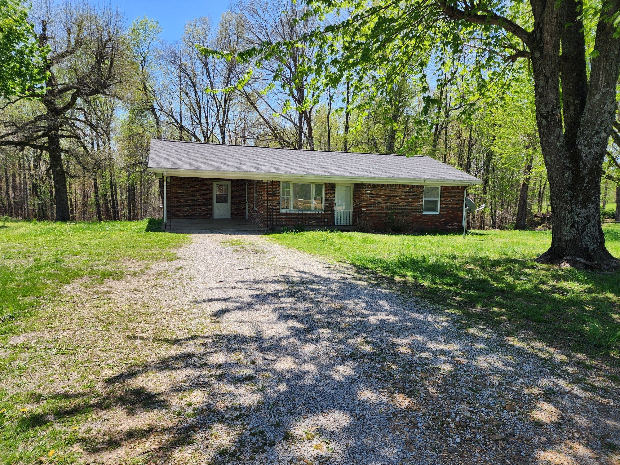288 Dotson Road Lafayette, TN 37083 - Photo 3 of 25 a front view of a house with a yard and trees
