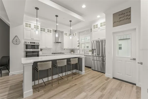 a kitchen with granite countertop a sink cabinets and stainless steel appliances