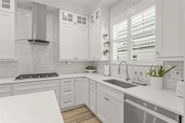 a kitchen with cabinets appliances a sink and a window