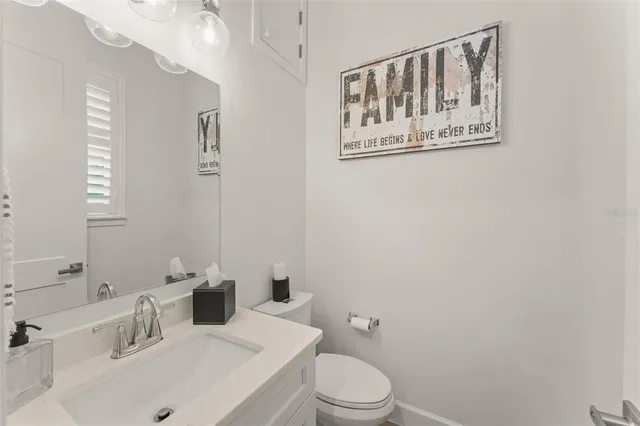 a white toilet sitting next to a bathroom sink
